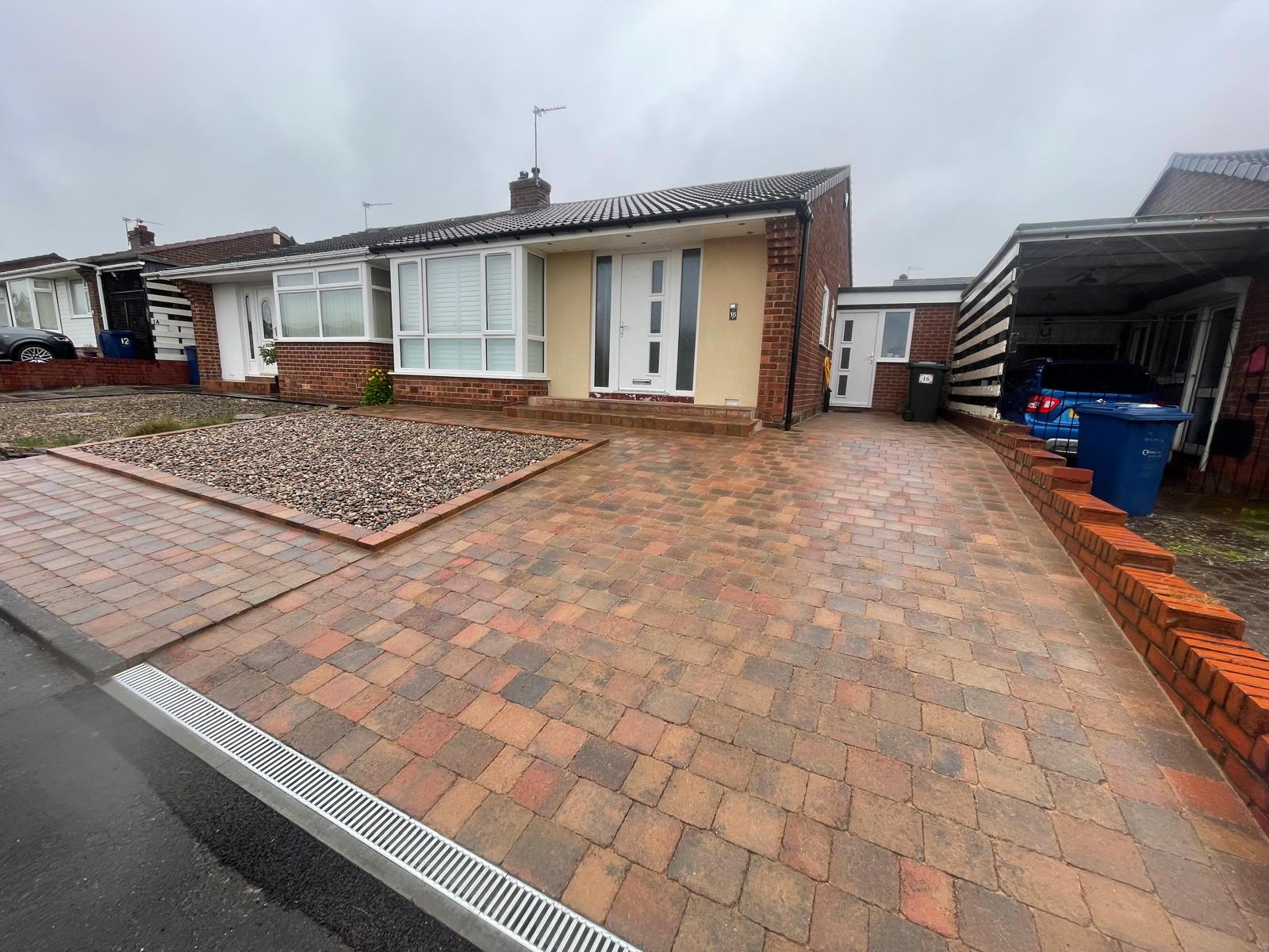 Autumn mix tumbled block driveway with a contrasting charcoal soldier-course border — The Vale Company