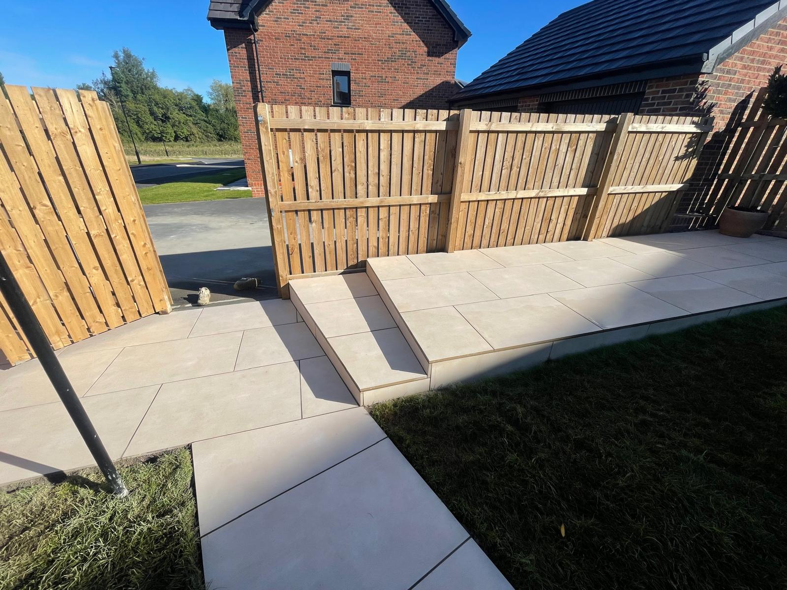 Buff porcelain path and single step with a flush edge to the lawn — The Vale Company