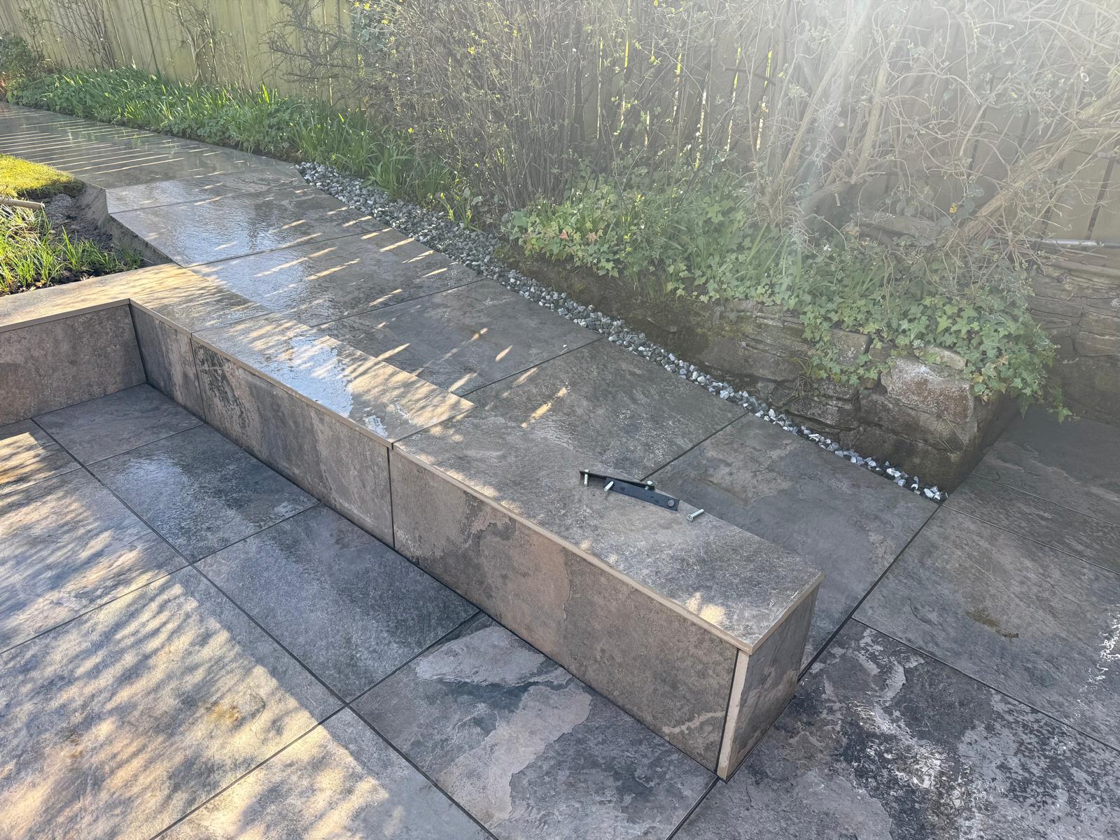 Porcelain-clad step and raised bed edge with the same porcelain used on the terrace — The Vale Company