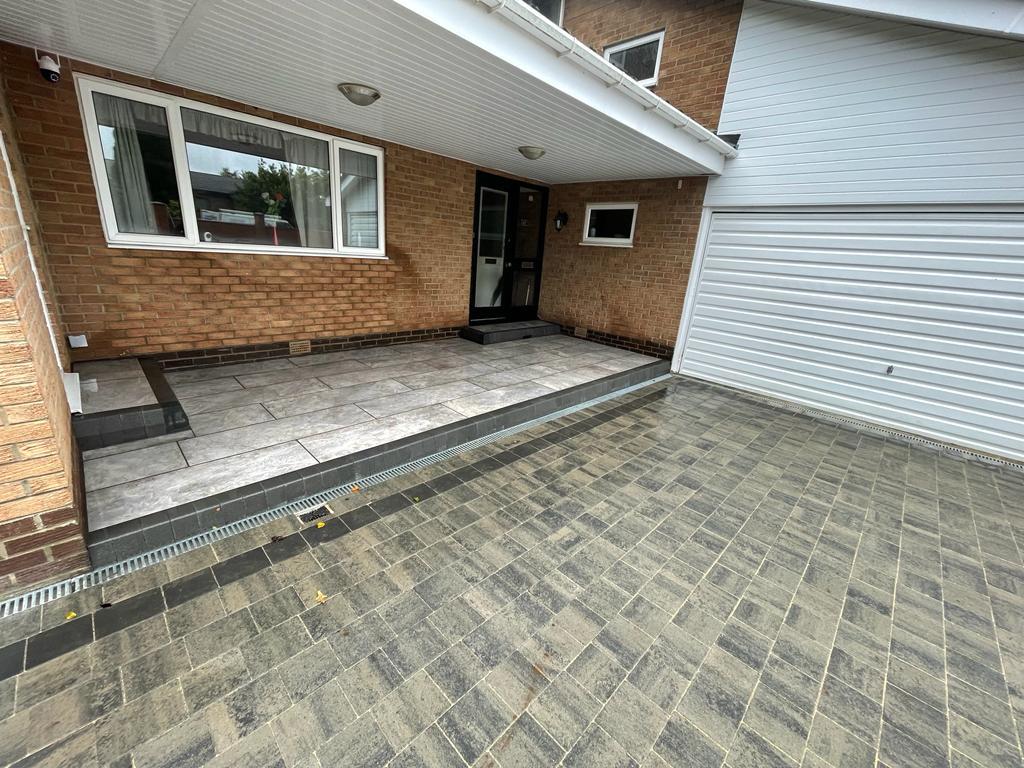Large-format grey porcelain terrace with a flush ACO channel drain at the house — The Vale Company