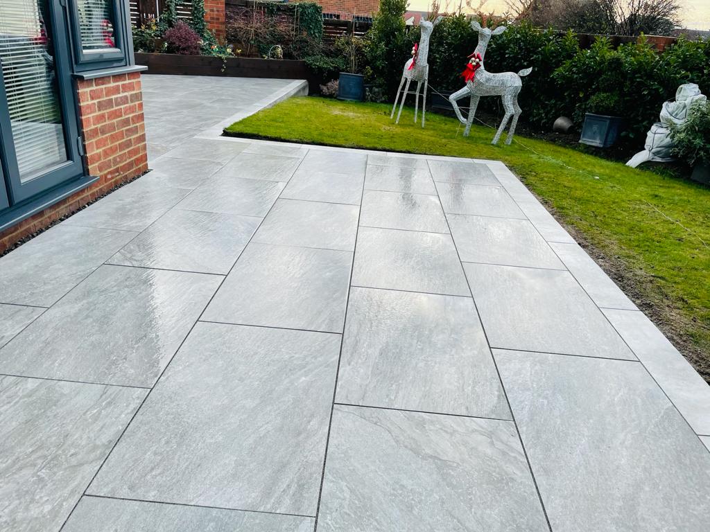 Grey porcelain terrace sized around an outdoor seating area — The Vale Company