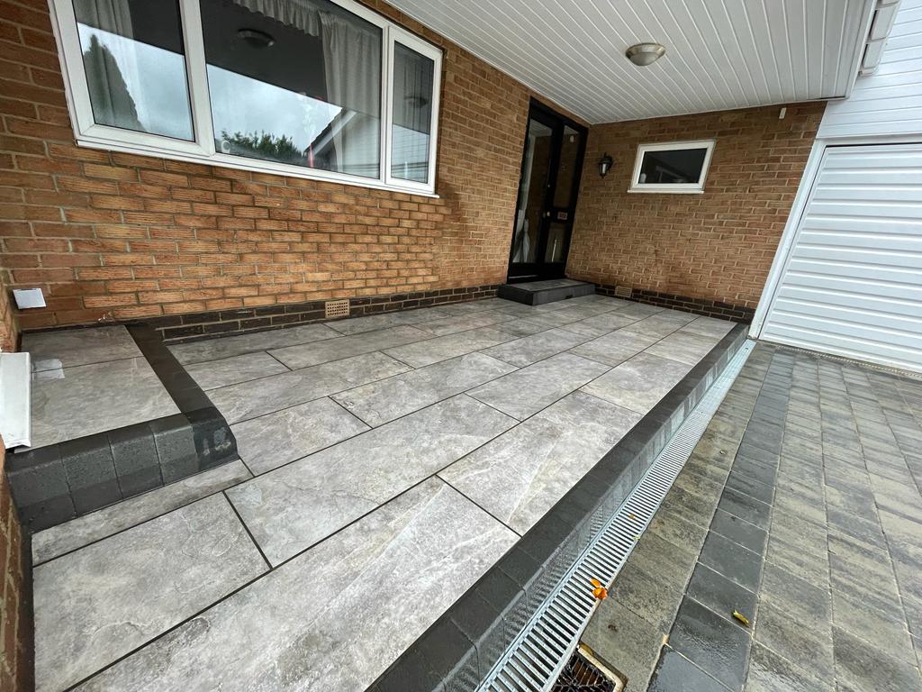 Travertine-effect porcelain patio with a matching bullnose step — The Vale Company
