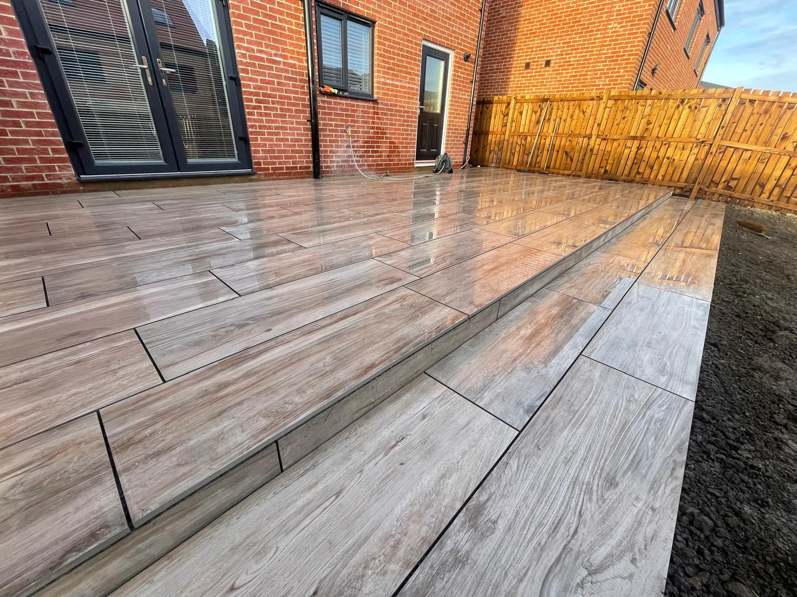 Plank wood-effect porcelain terrace with a wide step down — The Vale Company