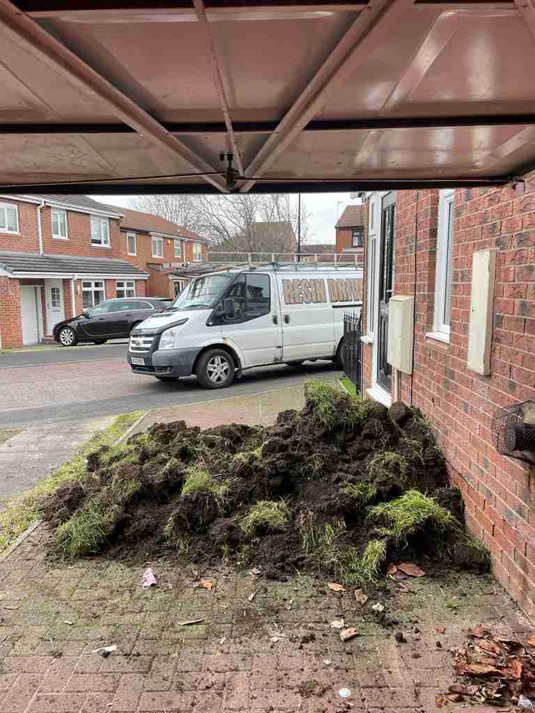 Before: turf lifted and stacked at a front garden ahead of a resin bound driveway — The Vale Company