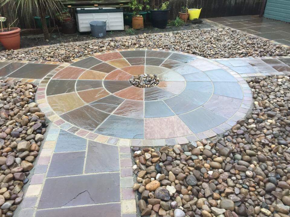 Buff Indian sandstone patio with a circular medallion feature at its centre — The Vale Company
