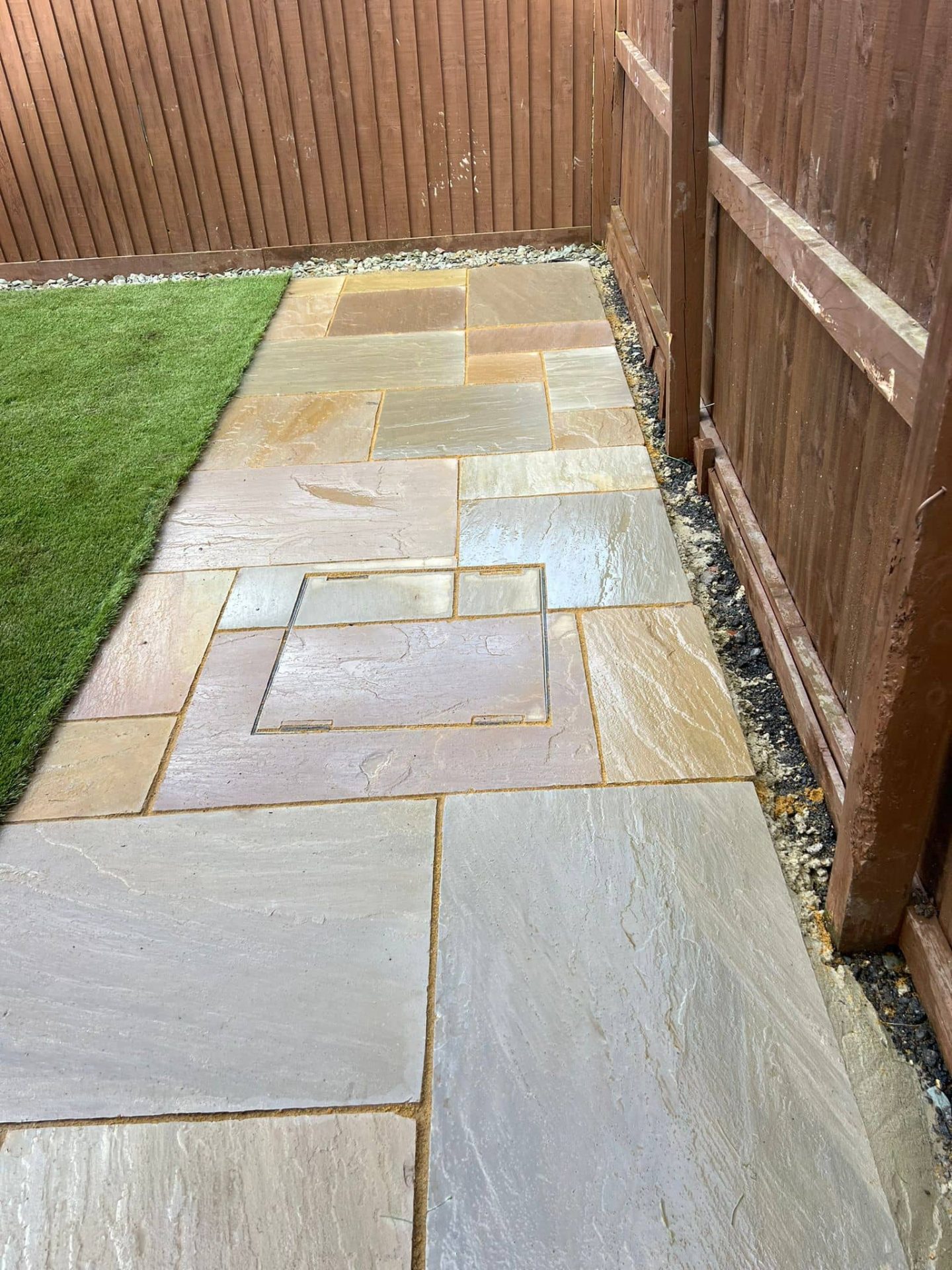 Sandstone side path with a recessed cover cut into the coursing and a gravel margin at the fence — The Vale Company