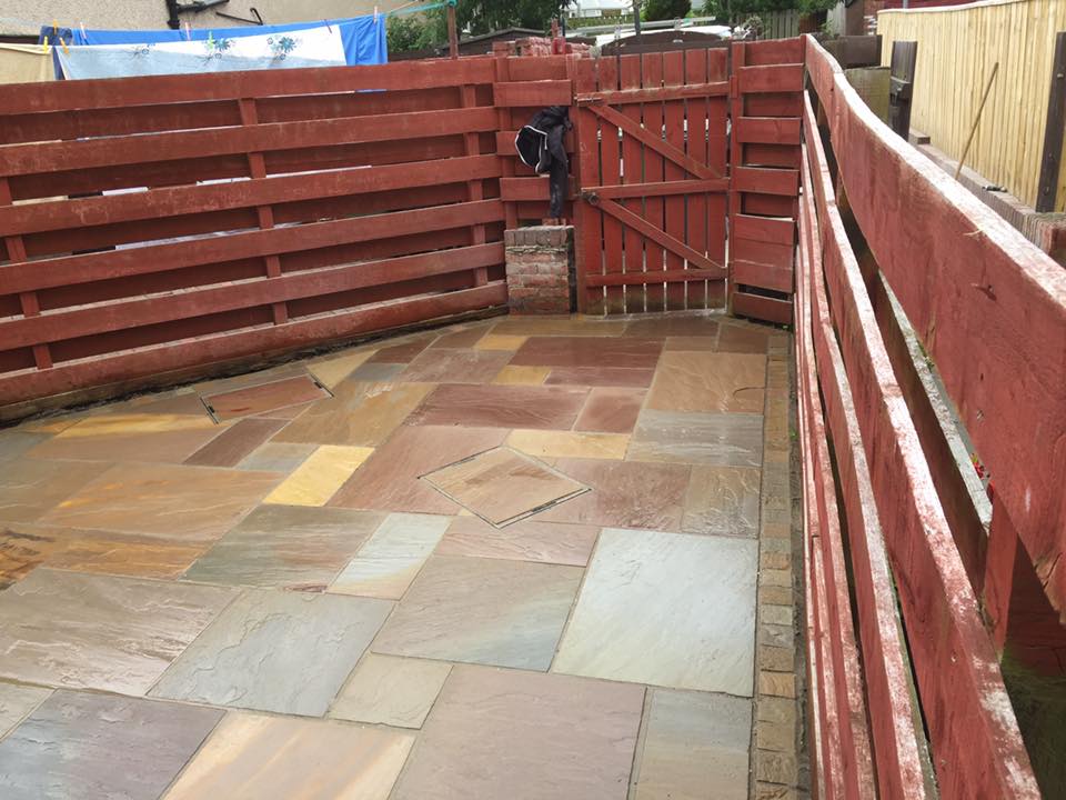 Autumn Indian sandstone yard with two inspection covers cut in and infilled with matching stone — The Vale Company