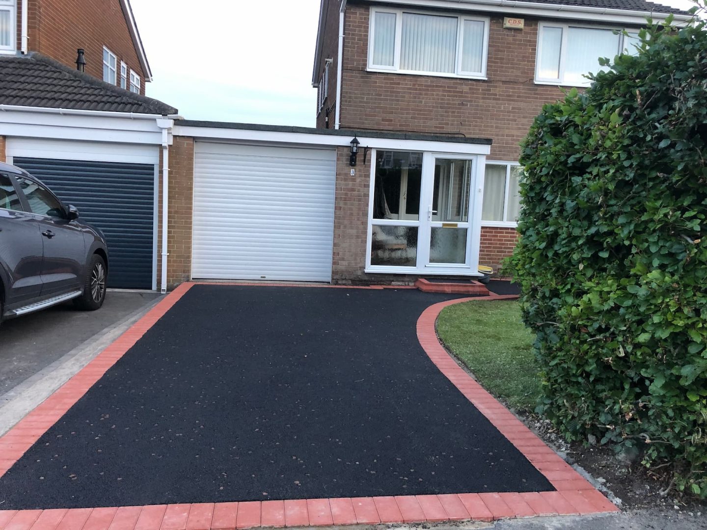 Tarmac driveway with a red block paved border curving round to the front door — The Vale Company